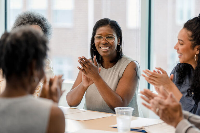 Women sitting at board room table