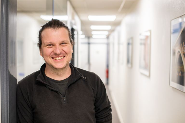 A photo of a man in a corridor